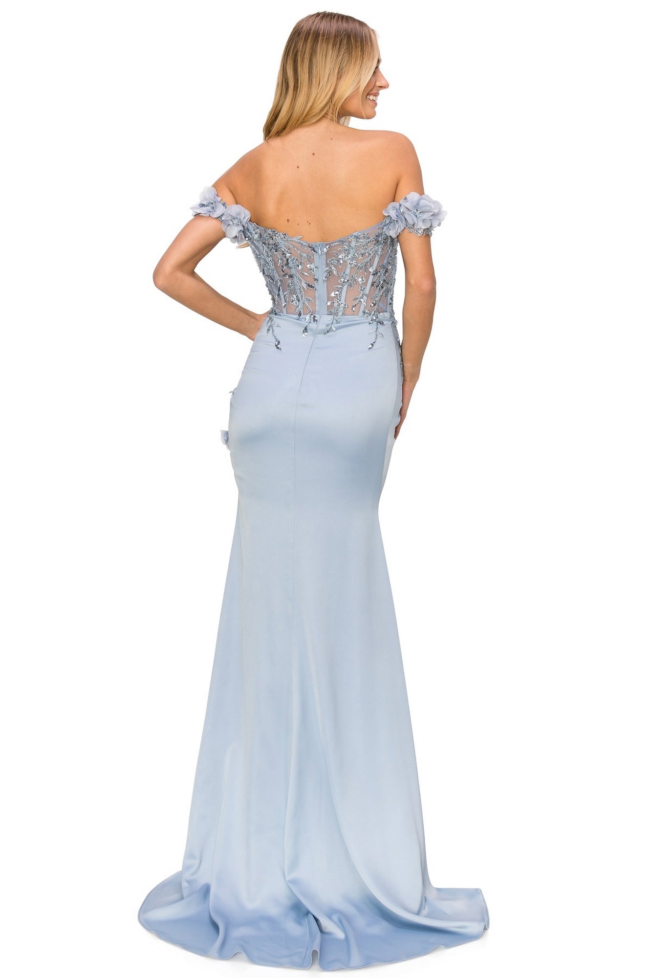 A woman stands facing away in the Off-the-Shoulder Floral Embroidered Prom Dress 8050J, featuring a light blue hue, floral bodice details, and sheer back panels.